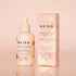 BKIND hair serum bottle and packaging on a pink background