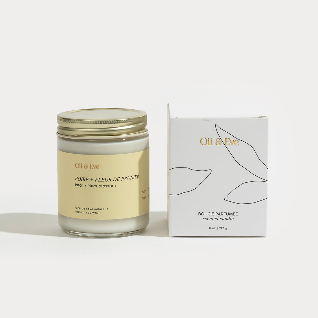 Jar of Oli &amp; Eve candle with packaging on a white background