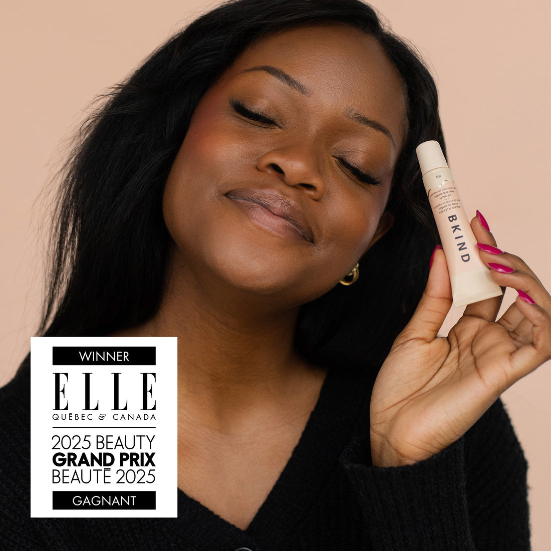 Woman holding a skincare product with an &
