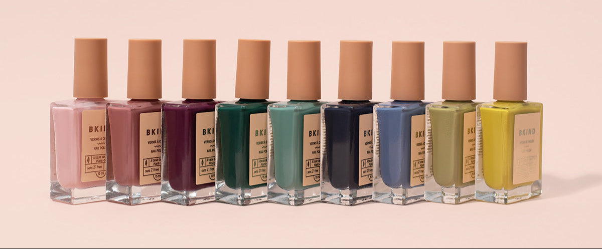 Row of nail polish bottles with visible brand name on a beige background