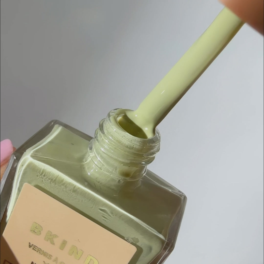Application of a creamy celadon green nail polish