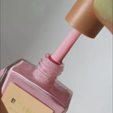 Application of a light pink nail polish shade
